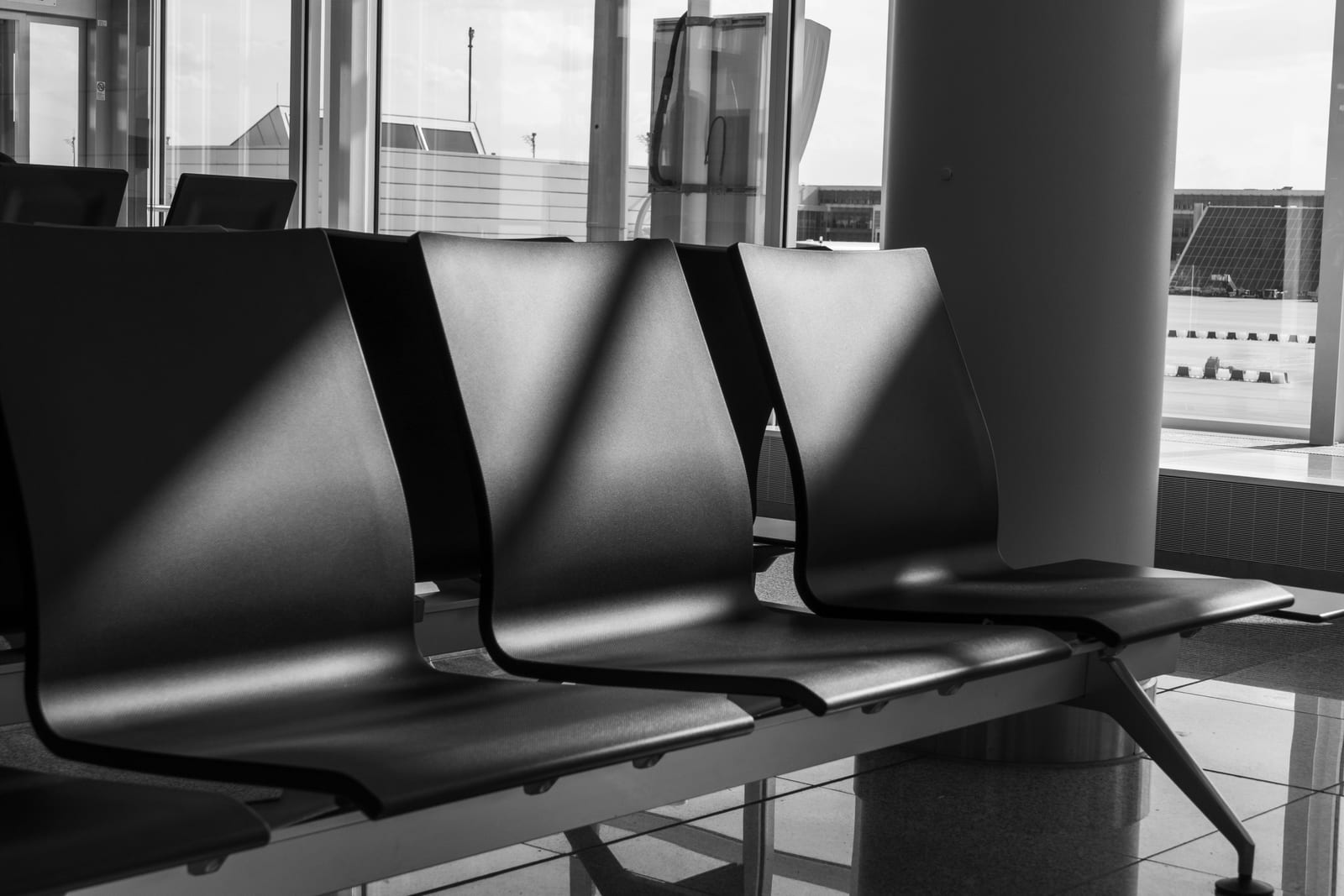 An empty waiting room chair with a case folder resting on it.